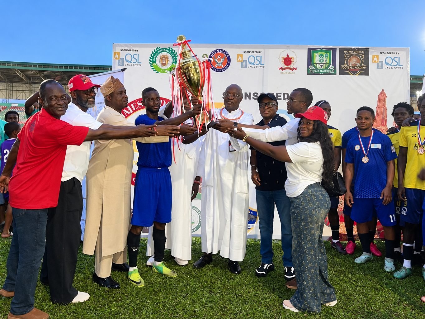 Teams and officials with the trophy at the Coronation Invitational final