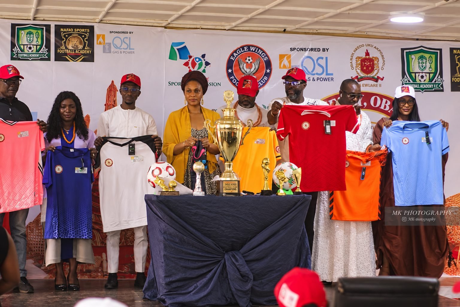 Sponsored team jerseys and trophies on display beneath the tournament banners