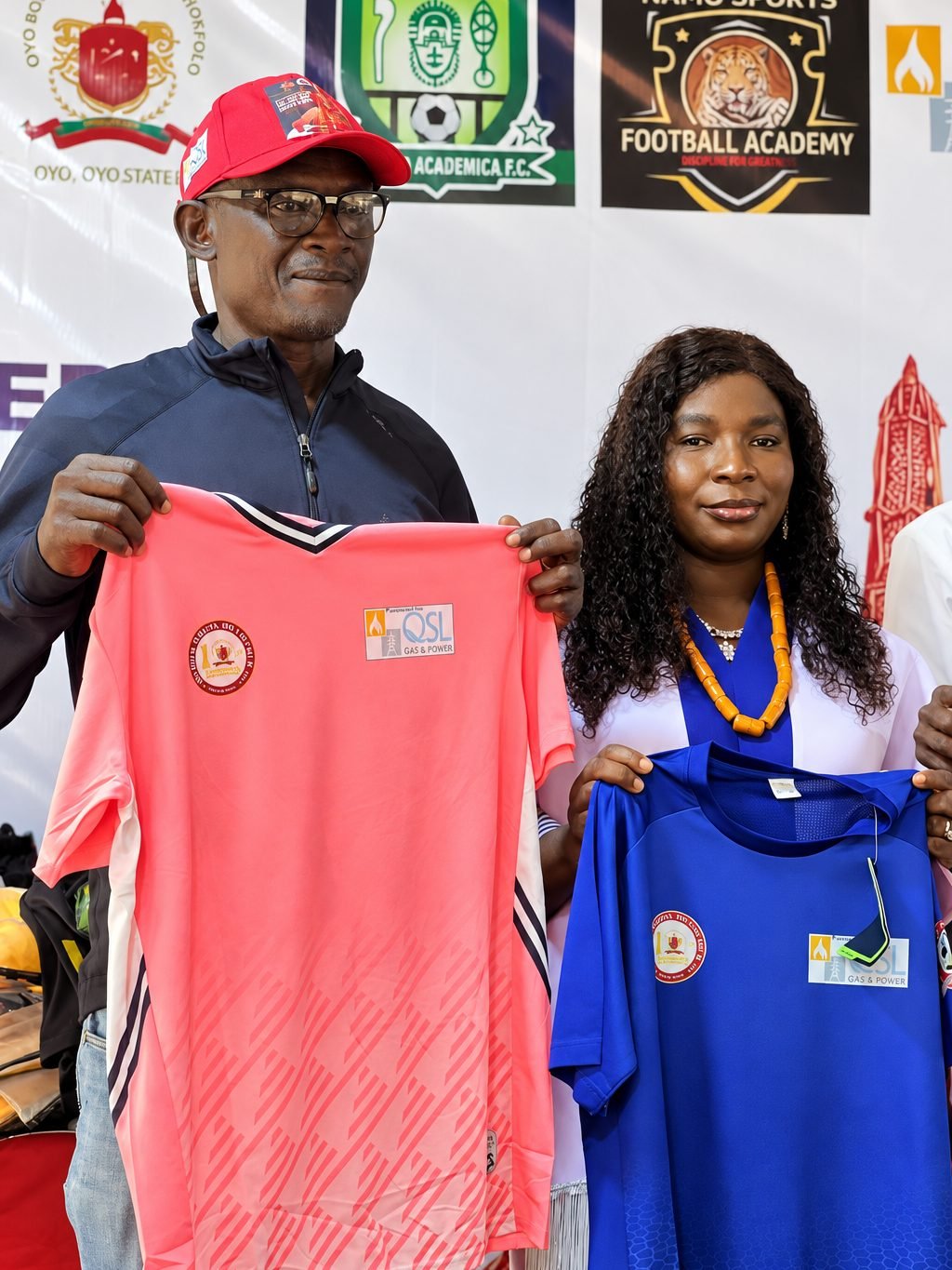 A QSL representative presents team jerseys